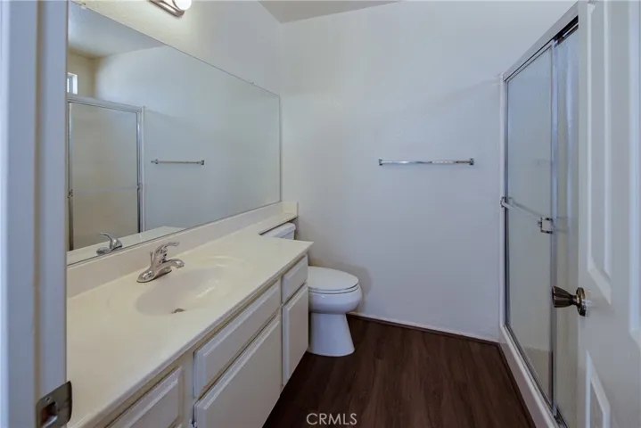 En-Suite master bath with wood type laminate floors and large shower.