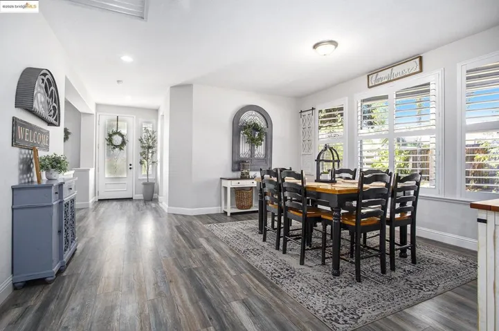 Dining room featuring a healthy amount of natural light, laminate wood-style floors, and recessed lighting