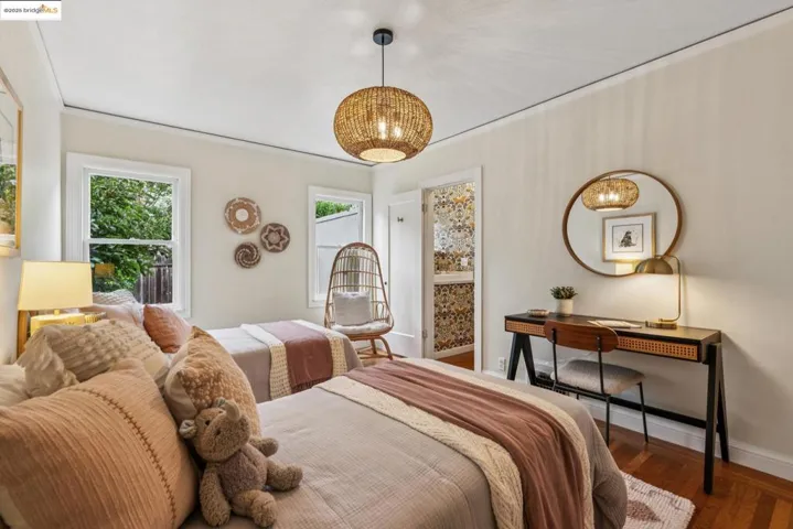 Bedroom featuring wood finished floors and baseboards