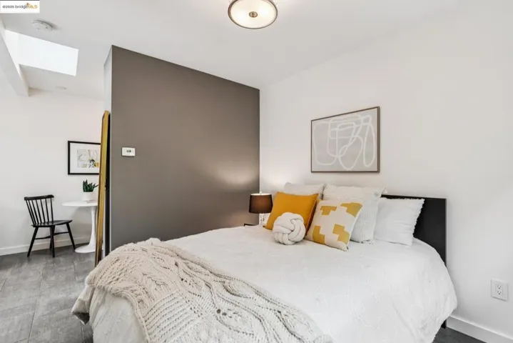 Bedroom featuring baseboards and a skylight