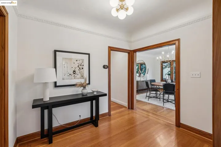 Hallway featuring a chandelier and light wood-type flooring