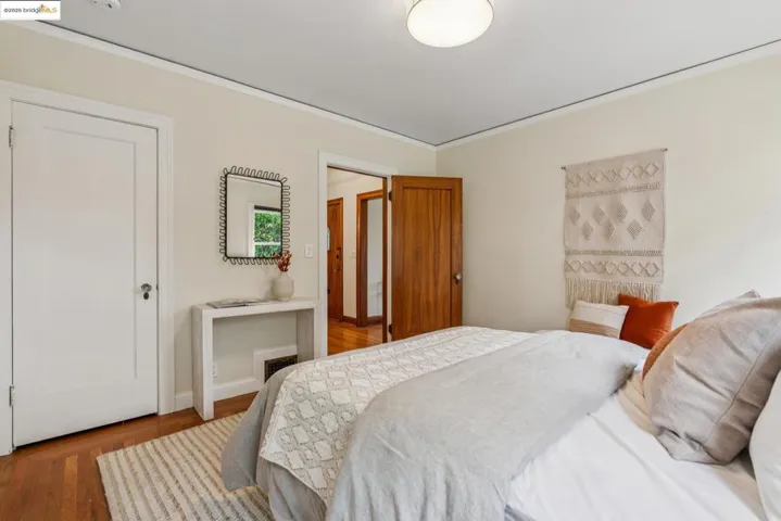 Bedroom featuring wood finished floors and ornamental molding