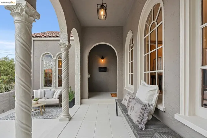 Doorway to property featuring stucco siding, outdoor lounge area, and a tile roof