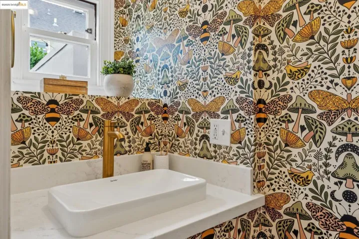 Bathroom featuring a sink and wallpapered walls