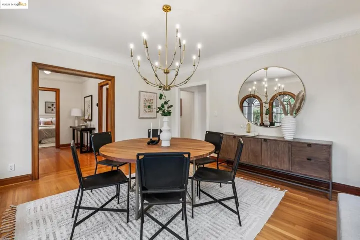 Dining area featuring ornamental molding, a chandelier, and light wood-style floors