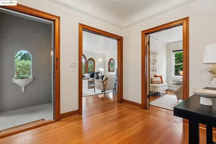 Hallway featuring light wood-style floors and ornamental molding