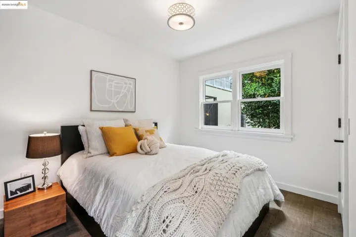 Bedroom with baseboards and dark wood-style flooring