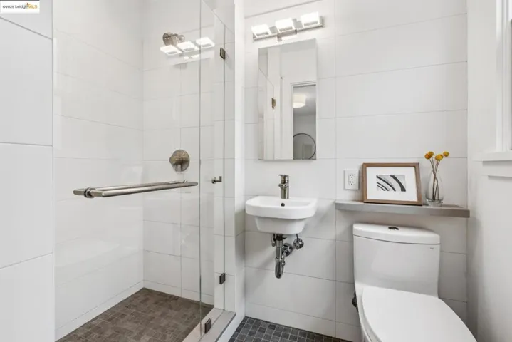 Bathroom with a stall shower and tile walls