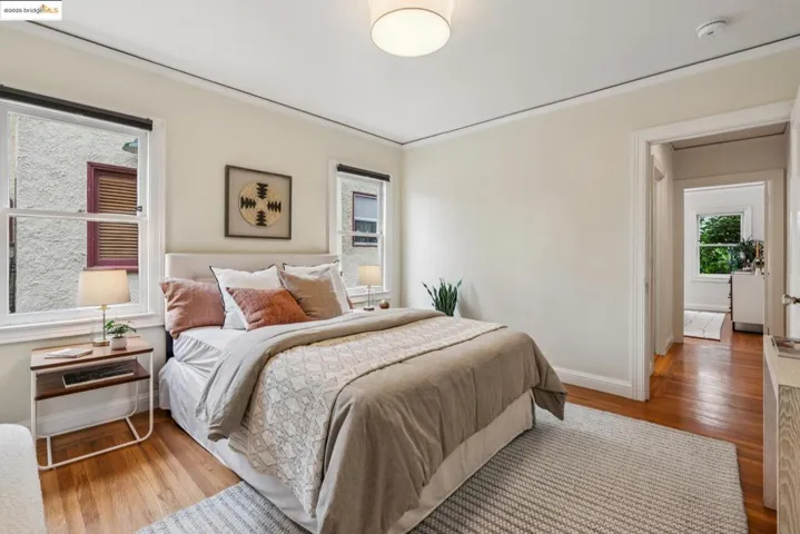 Bedroom with wood finished floors and baseboards