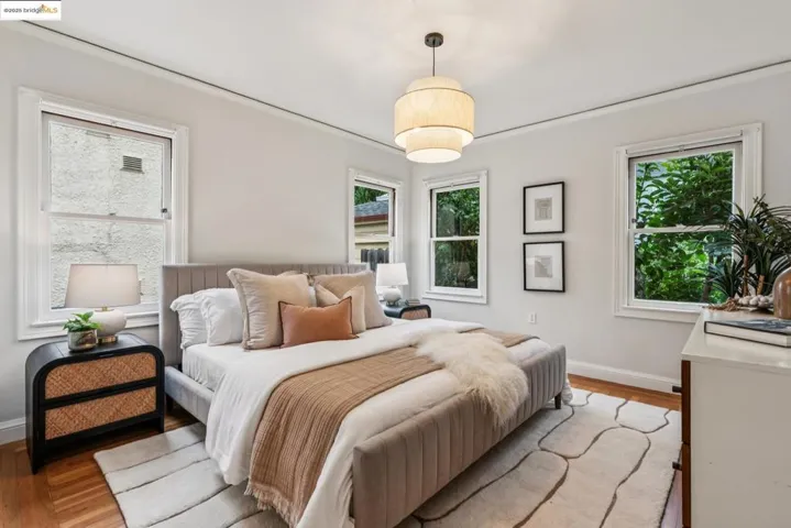 Bedroom with wood finished floors and baseboards