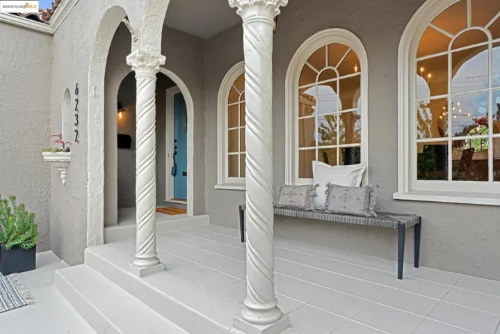 View of exterior entry with stucco siding and a porch