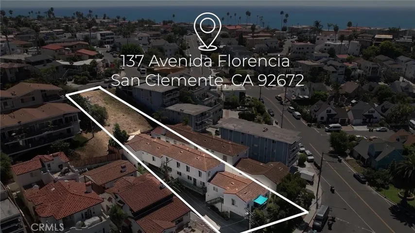 Arial view of property showing vacant land behind building, leading to Del Reposo.