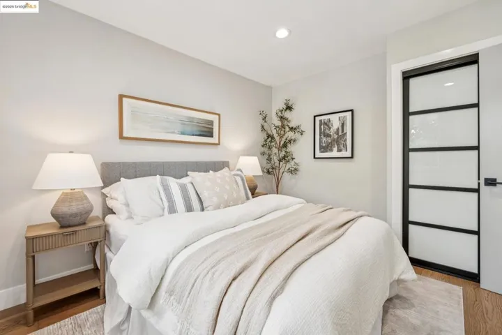 Bedroom with wood finished floors and recessed lighting