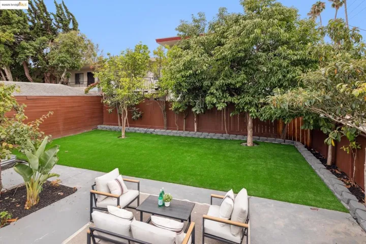 Fenced backyard with a patio area and an outdoor hangout area