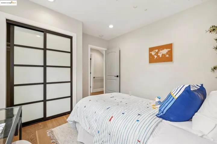 Bedroom featuring light wood finished floors, a closet, and recessed lighting