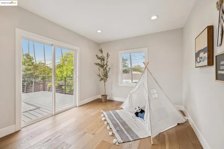 Game room with light wood-style floors and recessed lighting
