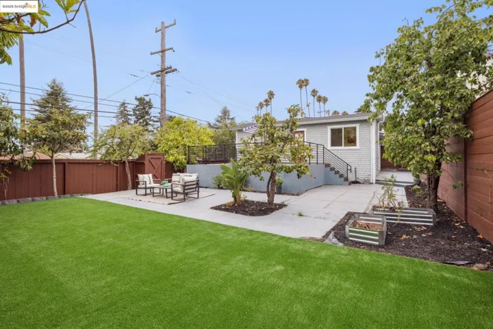 Rear view of property featuring a patio area and a fenced backyard