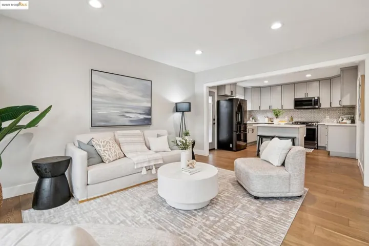 Living area with light wood-style flooring and recessed lighting