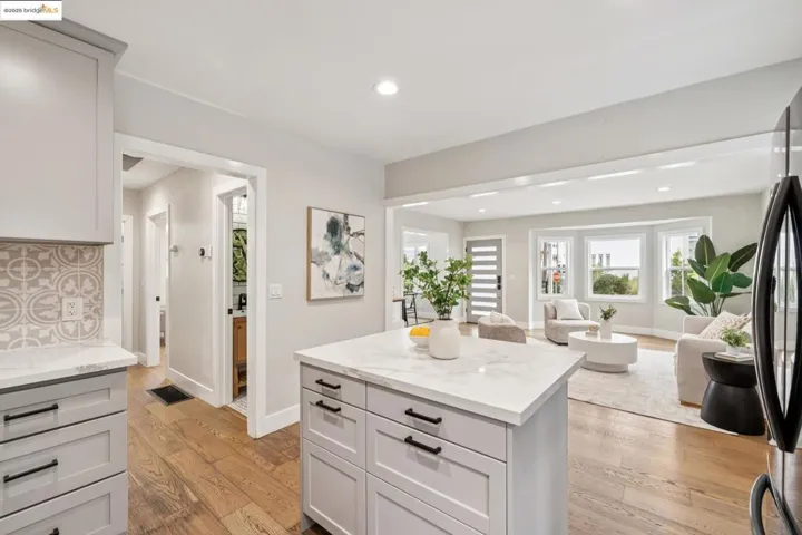 Kitchen featuring light wood-style floors, open floor plan, recessed lighting, freestanding refrigerator, and a kitchen island
