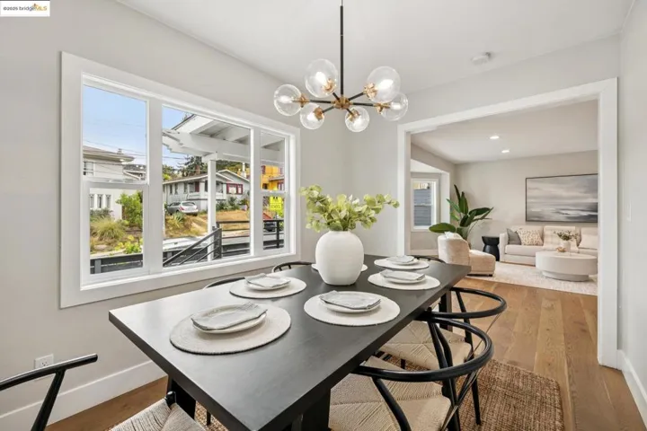 Dining space with light wood-style floors and a chandelier