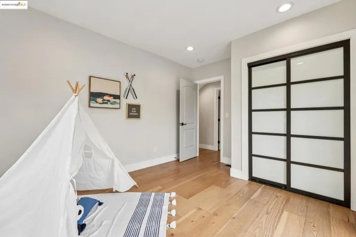 Unfurnished bedroom featuring a closet, light wood-style floors, and recessed lighting