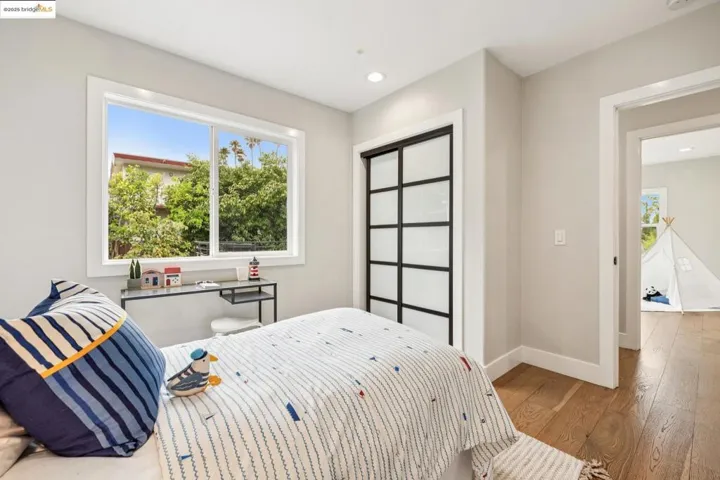Bedroom with wood finished floors and recessed lighting