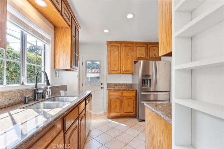 Lots of counter top space to cook, recessed lights and lots of natural light with private green space view from kitchen sink.