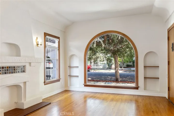 Faux Fireplace with Spanish tile inlay. Arched picture window. Family Room.