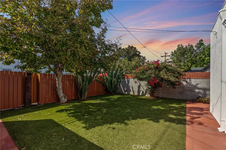 New artificial turf with low maintenance drought resistant landscaping.