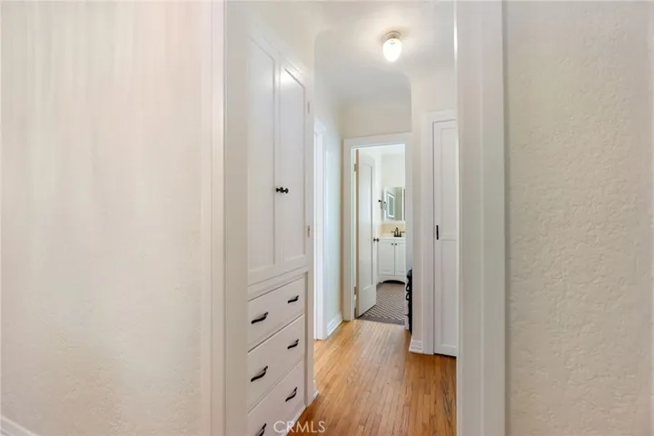 Hall way with built in storage and large closet for mops & vaccums.