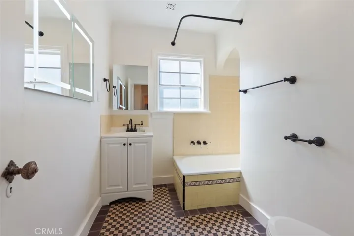 Bathroom new sink vanity, mirrored storage, and toilet.