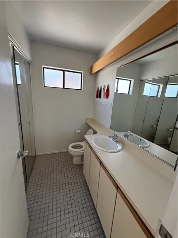 Upper 1/2 bath with laundry facilities, behind mirrored doors.