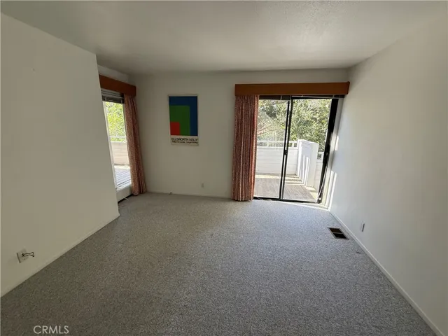  bedroom number two showing the sliding glass door and the second door on the left.