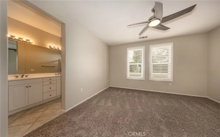 Main Bedroom with Ceiling Fan, New Carpet, New Paint, Plantation Shutters, View of the Golf Course, On Suite with Dual Vanities