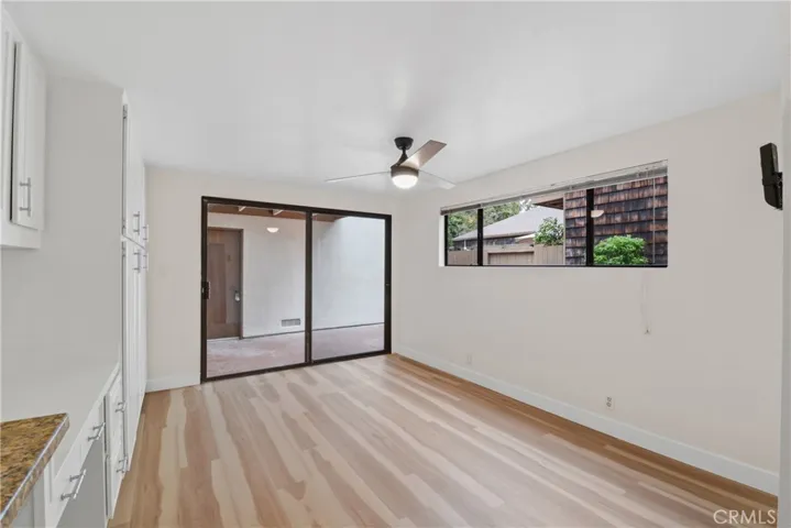 Light, bright family kitchen with new laminate flooring, decorative ceiling fan with light,