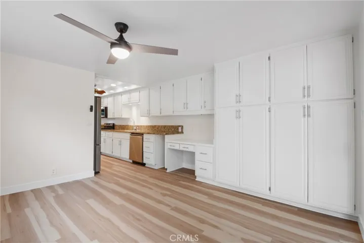 Another view from family kitchen featuring plenty of storage and a convenient kitchen desk.