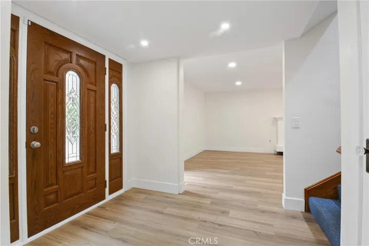 Welcoming entry with newer laminate flooring.