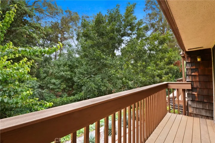 Primary Bedroom suite opens to newly replaced balcony, ideal for quiet relaxation and peaceful tree views