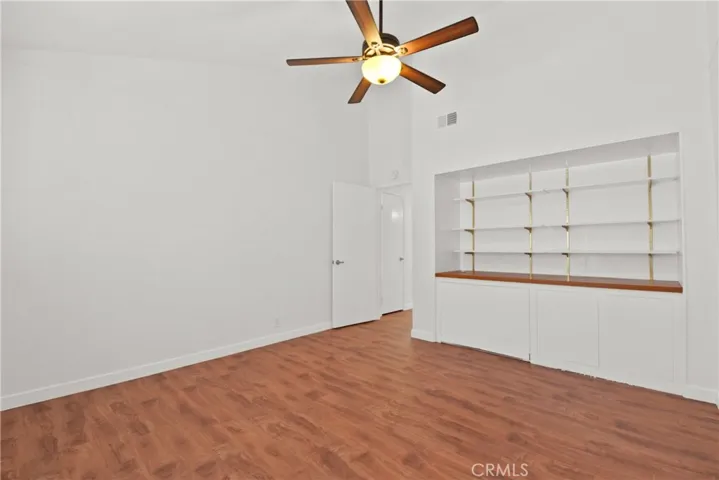 Front upstairs bedroom with shelves and cabinets