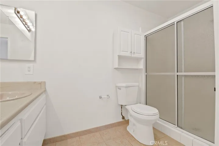 Center Hall  bathroom with ceramic tile flooring, spacious walk-in shower