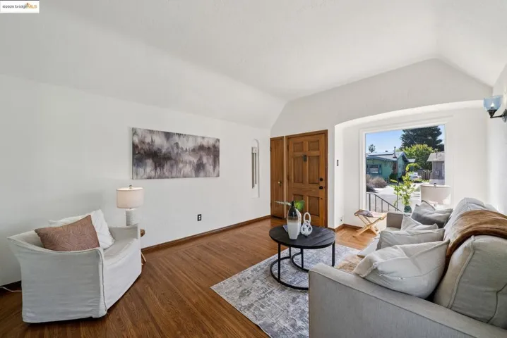 Living area featuring vaulted ceiling and wood finished floors