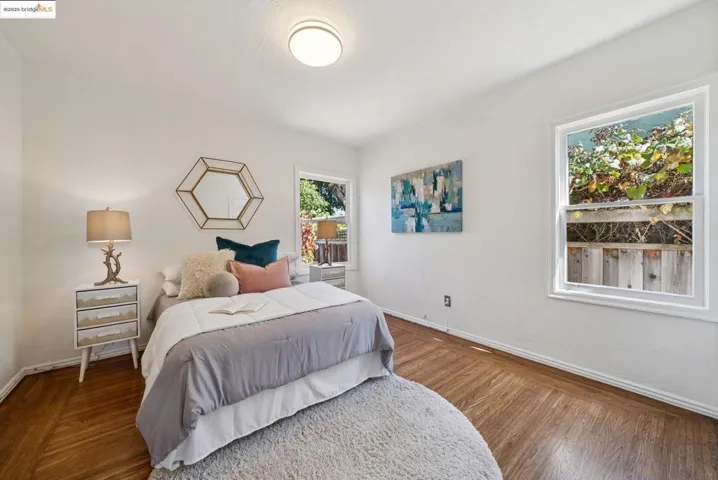 Bedroom featuring baseboards and wood finished floors