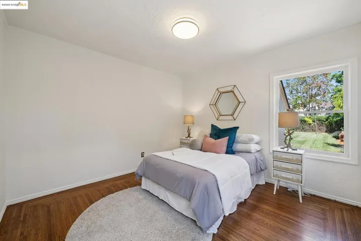 Bedroom featuring baseboards and wood finished floors