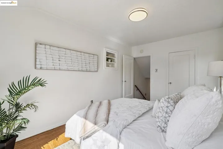 Bedroom featuring wood finished floors and a closet