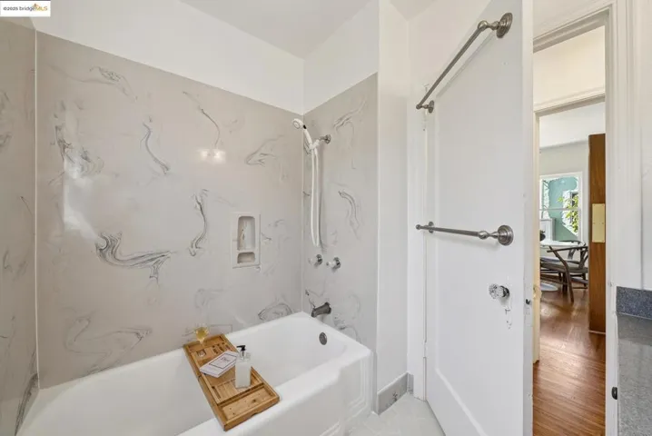 Full bathroom with a combined bath / shower with marble appearance