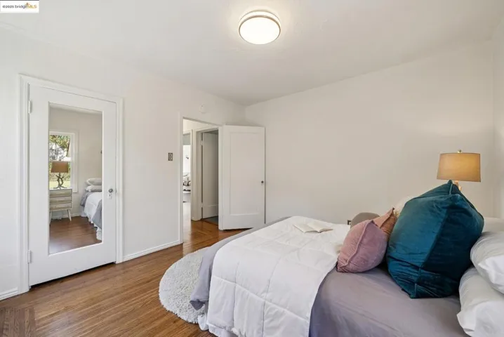 Bedroom with wood finished floors and baseboards