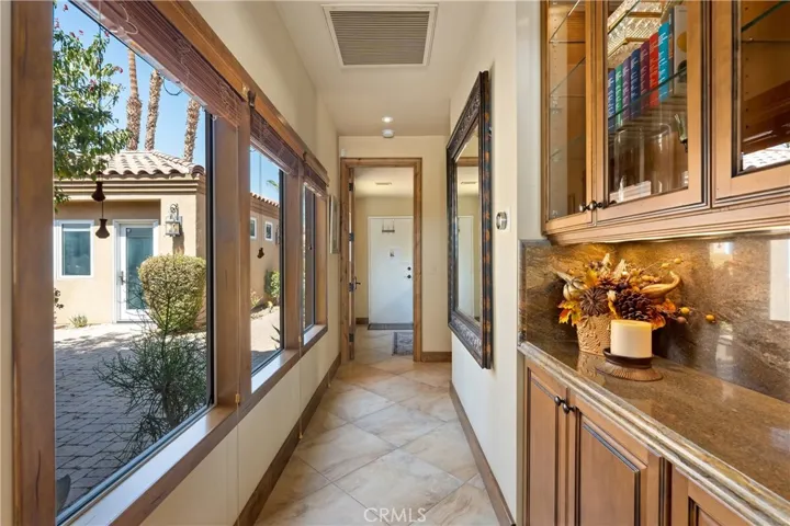 Hallway to bedroom 3 + ensuite, laundry area and garage.