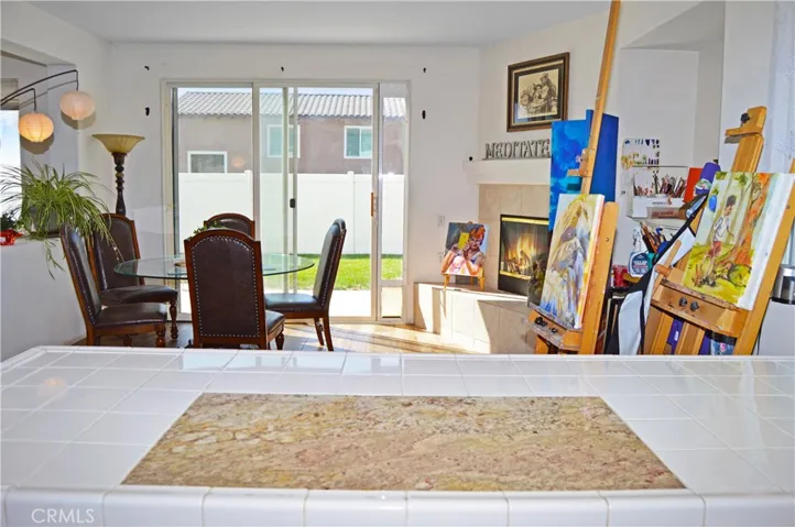 Light and Bright Kitchen with An Added Breakfast Bar with a Granite Insert for Dough-Making, Tile Floors, & a Pantry