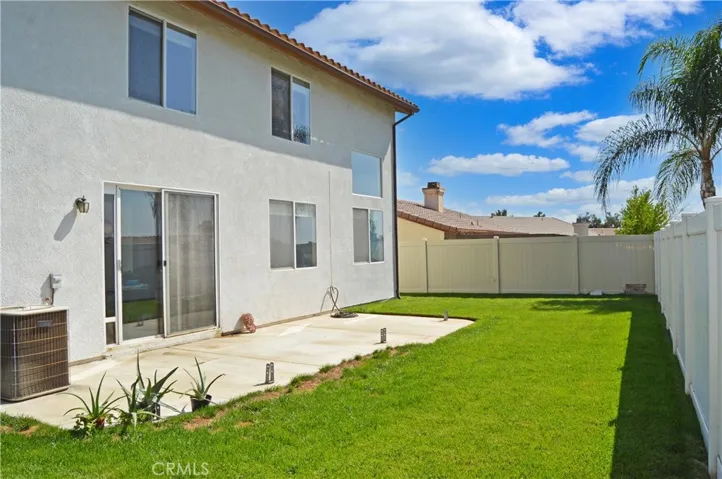 Nice-Sized Backyard with Concrete Patio, Lush Lawn, Vinyl Fencing by Neighbors & Wrought Iron Fencing to Enjoy Green Space Views to North