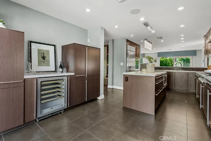 Wine fridge and drinks area surrounded by even more storage and another casual dining area / breakfast spot.